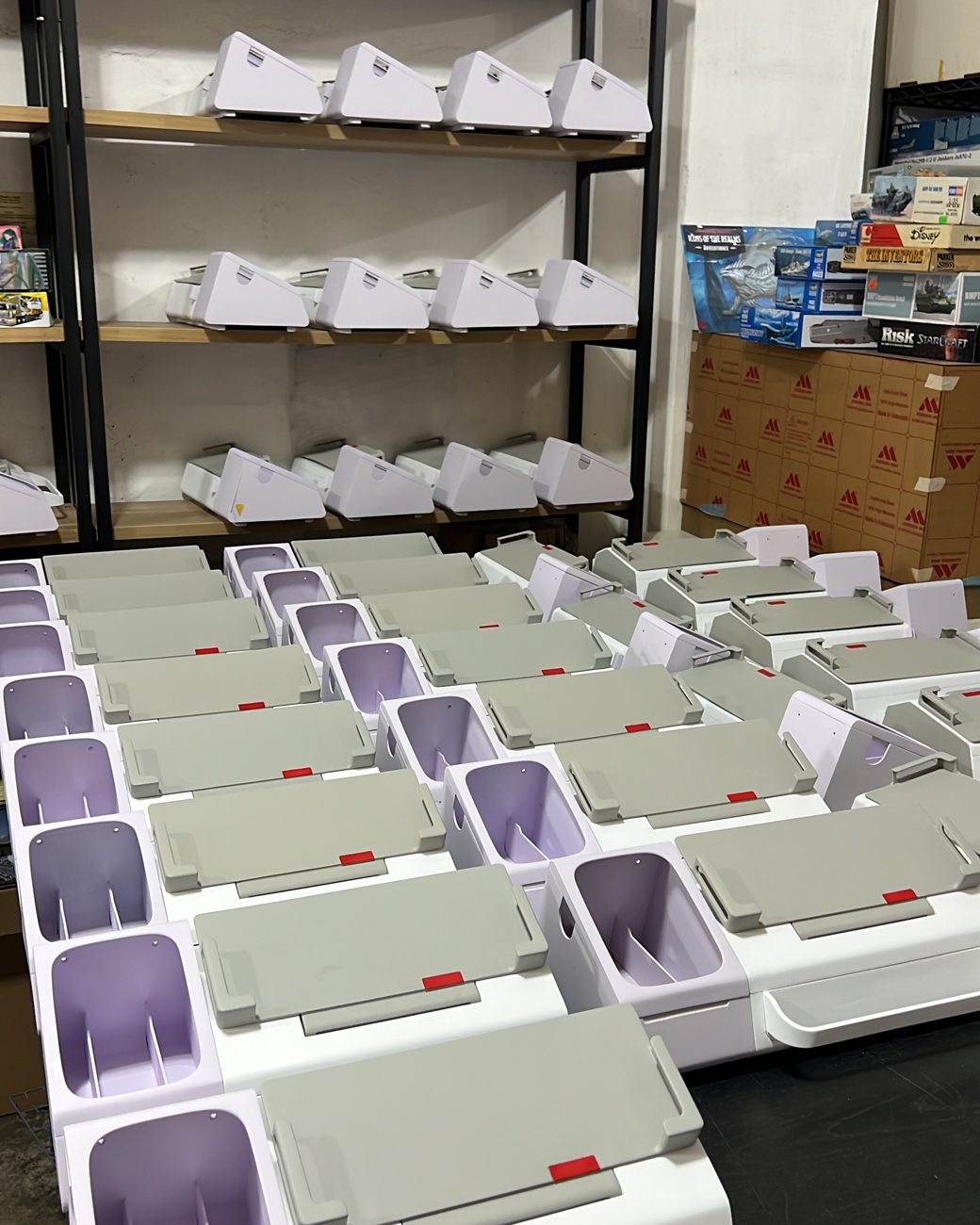 Rows of finished white eldercare telecoms device units produced for GovTech Singapore