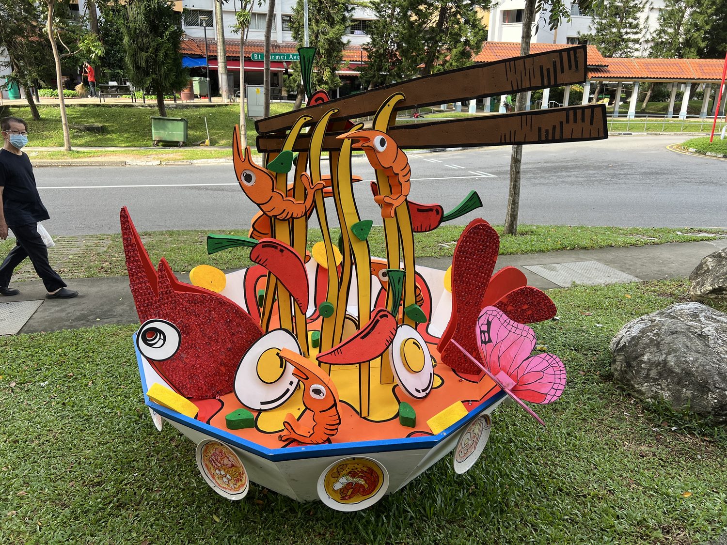 Oversized hand-painted foam food sculptures created with Radin Mas residents for a community celebration
